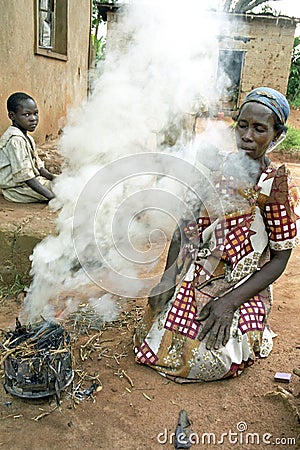 Portrait of Ugandan woman, fire and smoke Editorial Stock Photo