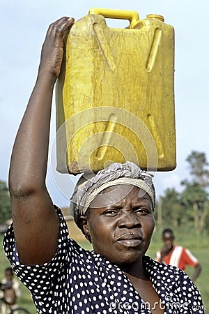 Portrait of Ugandan woman with jerry can on head Editorial Stock Photo