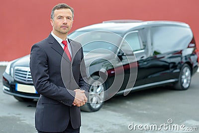 Portrait undertaker hearse in background Stock Photo