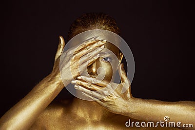 Portrait unearthly Golden girls, hands near the face. Very delicate and feminine. The eyes are open. Frame of hands Stock Photo