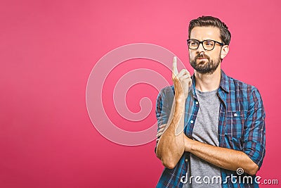 Portrait of unhappy determined european male with bristle touching chin while thinking and looking with serious and worried look Stock Photo