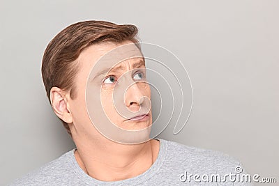 Portrait of unhappy frightened confused blond mature man Stock Photo