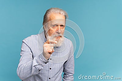 Portrait of unhappy grumpy pissed off senior mature man on blue background copy space. Negative human emotions, face Stock Photo