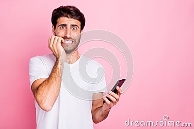 Portrait of unhappy negative worried scared middle eastern use hold cellphone read novelty get notification about Stock Photo