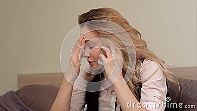 Portrait of unhappy young woman making annoyed phone call at home Stock Photo