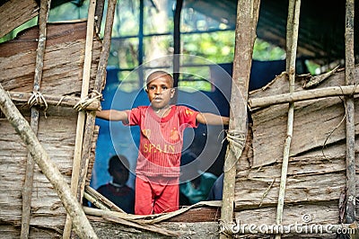Portrait of unidentified Papuan little boy in red Editorial Stock Photo