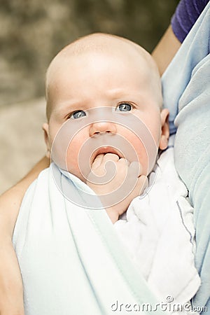 Portrait of a unique blue-eyed baby boy in teething pain Stock Photo