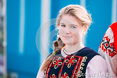 Portrait of unknown beautiful young woman girl in national folk clothes at Celebration of Maslenitsa Shrovetide holiday Editorial Stock Photo