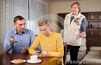 Portrait of upset girl scolded by parents at home Stock Photo