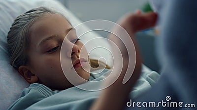 Portrait upset kid hospital ward playing with plush toy. Pediatric unit patient Stock Photo