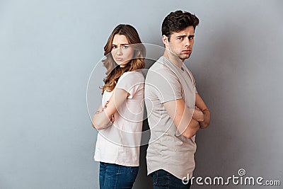 Portrait of an upset sad couple standing back to back Stock Photo