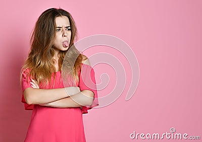 Portrait of an upset woman standing with arms folded and looking away Stock Photo