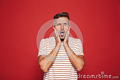 Portrait of uptight nervous man grabbing his face in confusion a Stock Photo