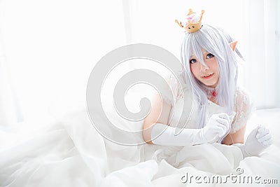 Portrait of vampire dracula young woman dress in white room Stock Photo