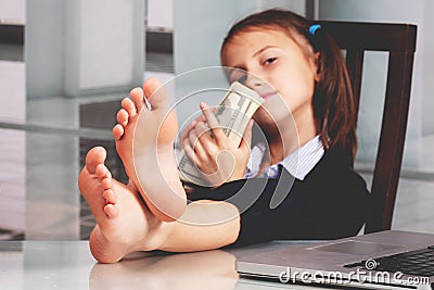 Portrait of very happy cute young business girl with bare feet on the table and counts money profit. Selective focus Stock Photo