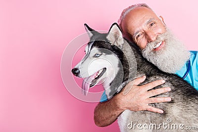 Portrait of veterinarian advertise high quality care for pets hug siberian husky isolated on pastel color background Stock Photo