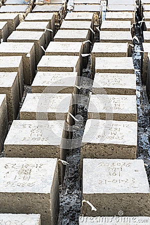 Portrait view of Rock bolder. Concrete cube over block background. Four square cinder blocks in a row Stock Photo