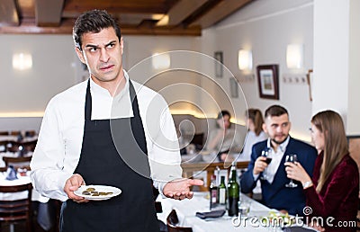 Waiter dissatisfied with small tip Stock Photo