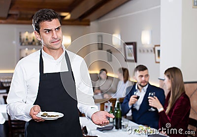 Waiter dissatisfied with small tip Stock Photo