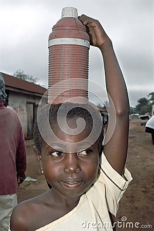 Portrait of water carrying Ghanaian young girl Editorial Stock Photo