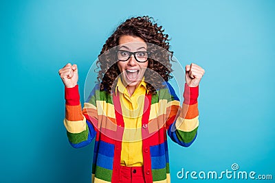 Portrait of wavy hair girl shock surprised win victory goal champion shout yes fists hands isolated over blue color Stock Photo