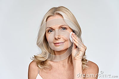 Portrait of woman holding cotton pad doing everyday routine makeup removing. Stock Photo