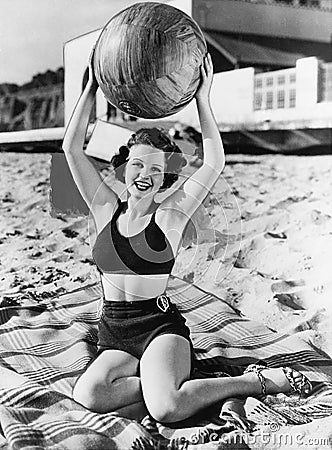 Portrait of woman with ball at beach Stock Photo