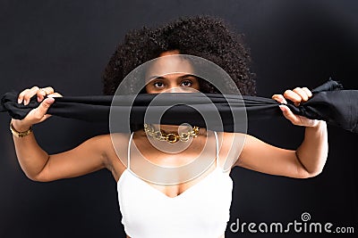 Portrait of a woman with a black cloth over her face in protest against machismo Stock Photo