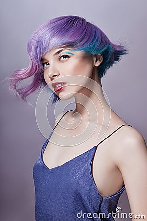 Portrait of a woman with bright colored flying hair, all shades of purple. Hair coloring, beautiful lips and makeup. Hair Stock Photo