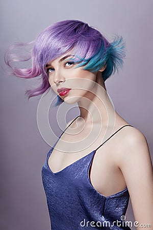 Portrait of a woman with bright colored flying hair, all shades of purple. Hair coloring, beautiful lips and makeup. Hair Stock Photo