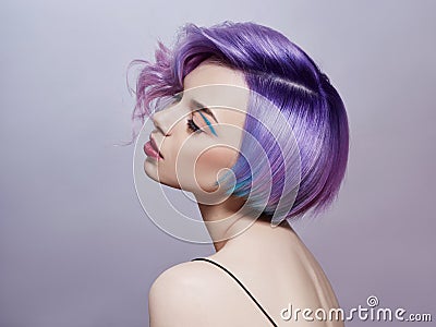 Portrait of a woman with bright colored flying hair, all shades of purple. Hair coloring, beautiful lips and makeup. Hair Stock Photo