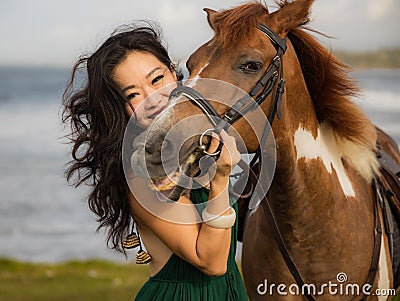 Portrait of woman and brown horse. Asian woman hugging horse. Romantic concept. Human animals relationship. Nature concept. Bali Stock Photo