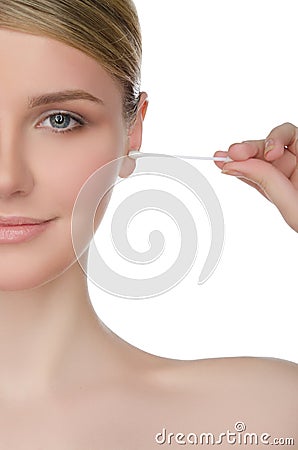 Portrait of woman brushing ear with cotton swab Stock Photo