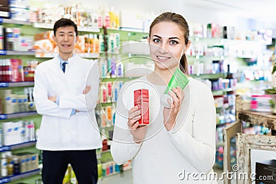 Portrait of woman client who is satisfied of recommended medicines in pharmacy. Stock Photo