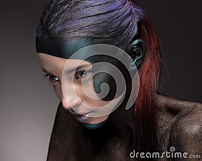 Portrait of a woman with creative make-up on a gray background. Stock Photo