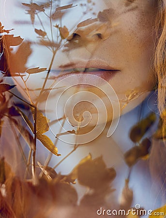 Portrait of a woman with a double exposure, the girl and the blurred nature of the photo is not in focus. The leaves on the woman. Stock Photo