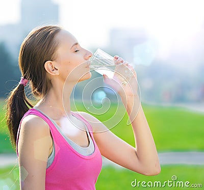 Portrait of woman drinking water after sport Stock Photo