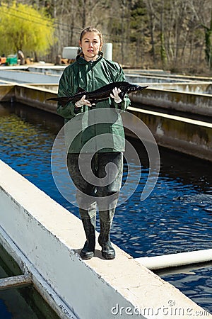 Woman demonstrating sturgeon Stock Photo
