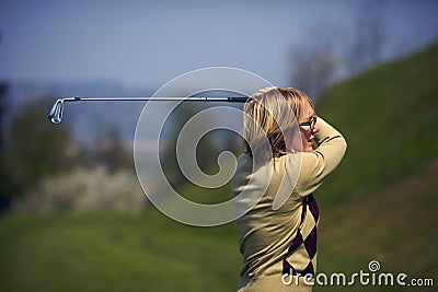 Portrait of woman golfer after a swing Stock Photo
