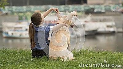 Portrait of a woman with her beautiful dog lying outdoors Stock Photo