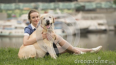 Portrait of a woman with her beautiful dog lying outdoors Stock Photo