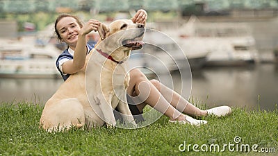 Portrait of a woman with her beautiful dog lying outdoors Stock Photo