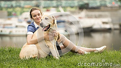 Portrait of a woman with her beautiful dog lying outdoors Stock Photo