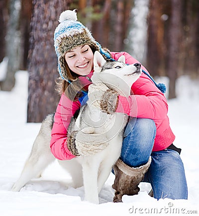 Portrait of a woman with her beautiful dog sitting outdoors Stock Photo