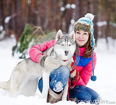 Portrait of a woman with her beautiful dog sitting outdoors Stock Photo