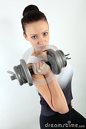 Portrait of a woman holding a big dumpbell for weight lifting workout Stock Photo