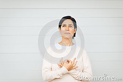 Portrait of woman holding gyan mudra next to heart Stock Photo