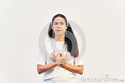 Portrait of woman holding gyan mudra next to heart Stock Photo