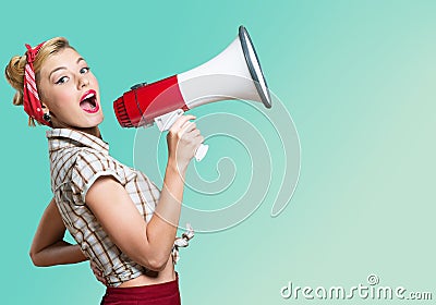 Portrait of woman holding megaphone, dressed in Stock Photo