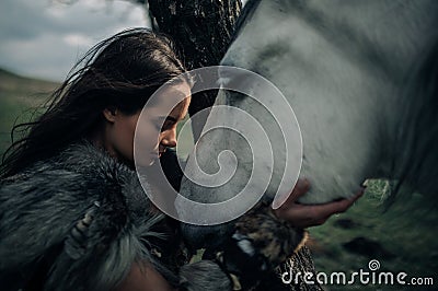 Portrait of woman in image of warrior amazon with her horse Stock Photo